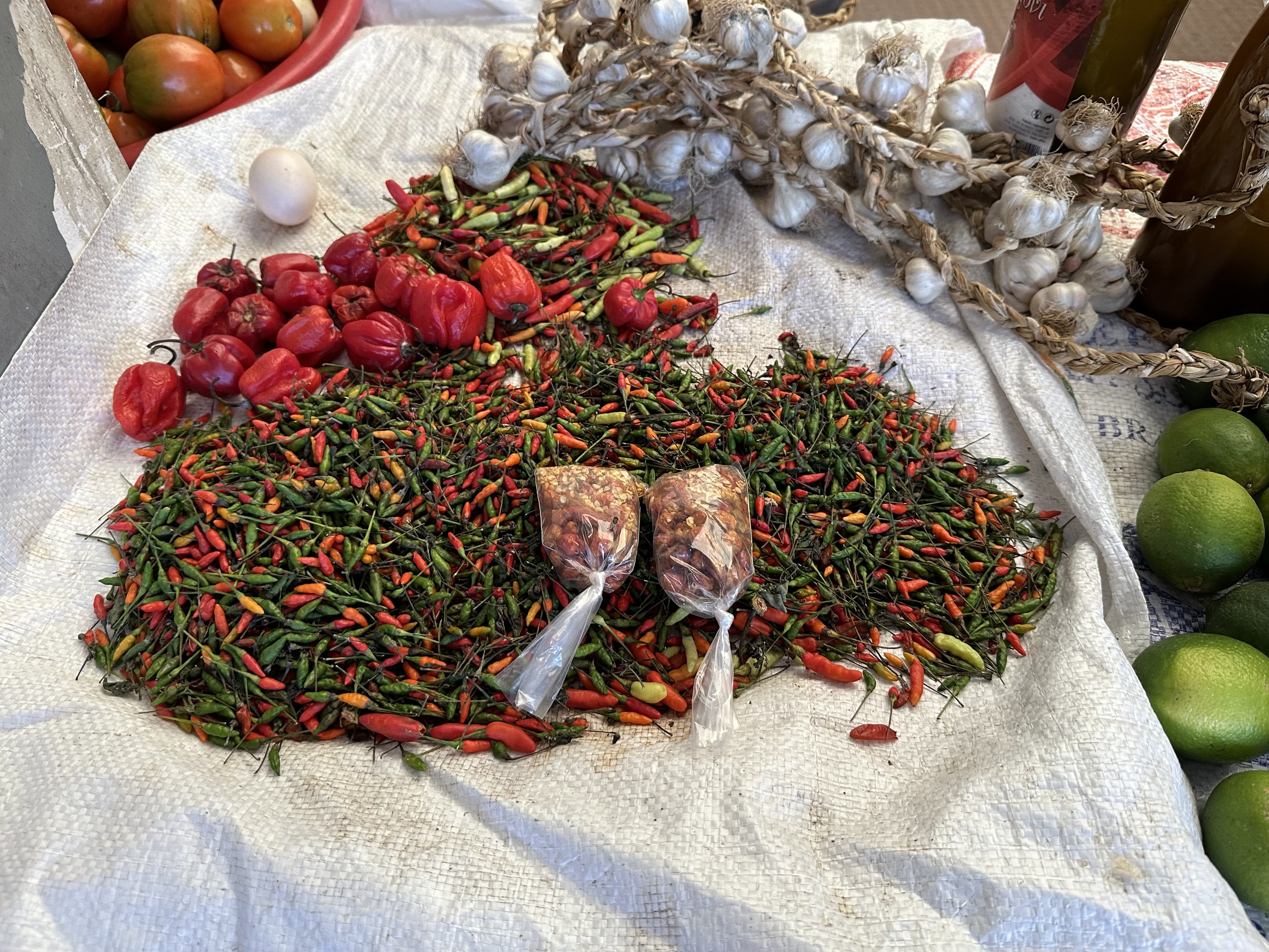 Groene en rode pepertjes, look en paprika's op de markt van Assomada, Cabo Verde.